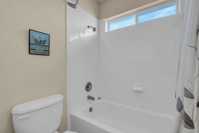 bathroom featuring shower / bathtub combination with curtain and toilet