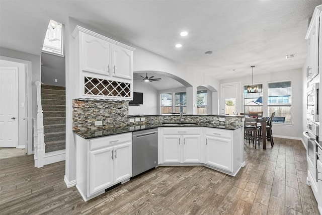 kitchen featuring white cabinets, decorative light fixtures, sink, and stainless steel appliances