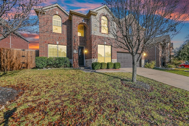 view of front of property featuring a yard and a garage