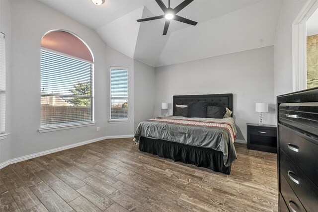 bedroom featuring ceiling fan, wood-type flooring, and lofted ceiling