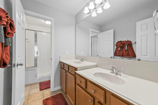 bathroom with tile patterned floors, vanity, and an enclosed shower