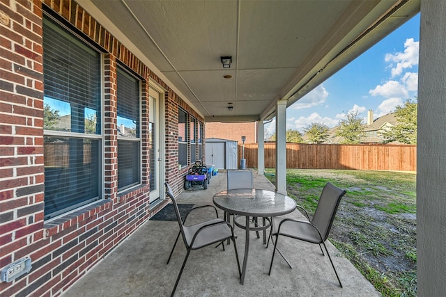 view of patio featuring a storage unit