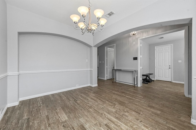 unfurnished room with dark hardwood / wood-style flooring and a notable chandelier