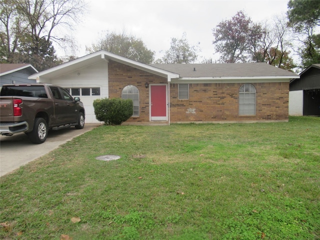 ranch-style house featuring a front yard and a garage