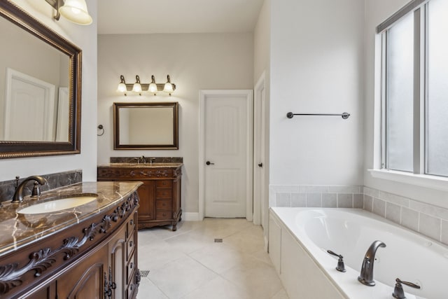 bathroom featuring tile patterned floors, vanity, and a bath