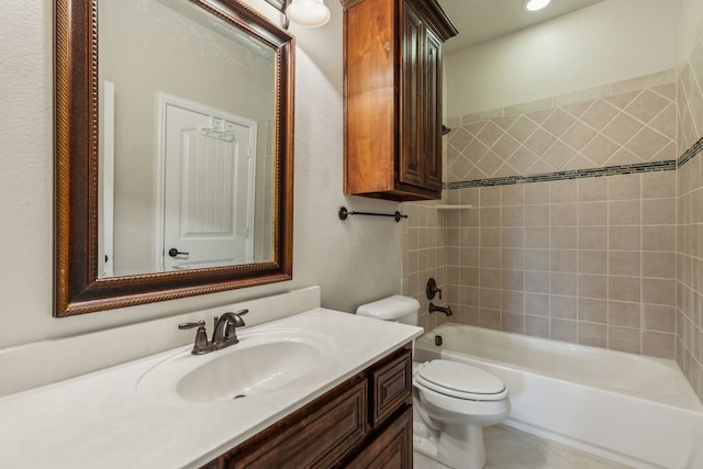 full bathroom with vanity, tiled shower / bath combo, and toilet