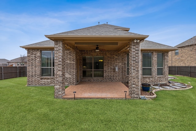 rear view of house featuring a patio, ceiling fan, and a lawn