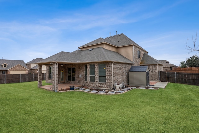 rear view of house featuring a storage shed, a patio area, and a lawn