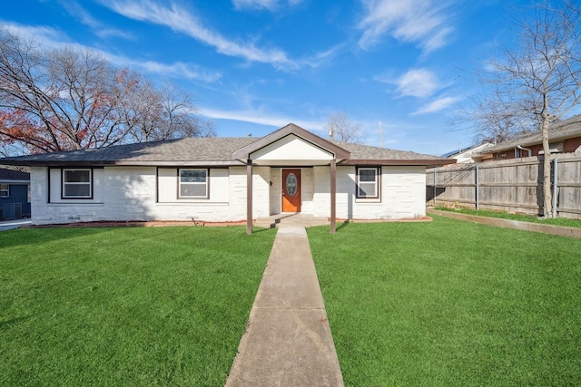 ranch-style home featuring a front yard, roof with shingles, fence, and brick siding