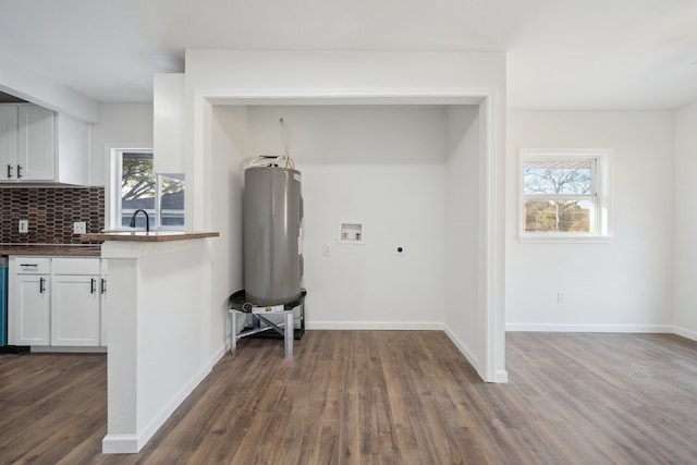 clothes washing area with hookup for a washing machine and dark wood-type flooring