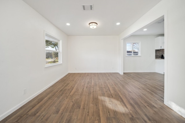 empty room with dark hardwood / wood-style floors