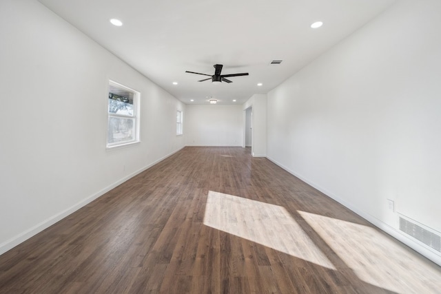 unfurnished living room featuring ceiling fan and dark hardwood / wood-style floors