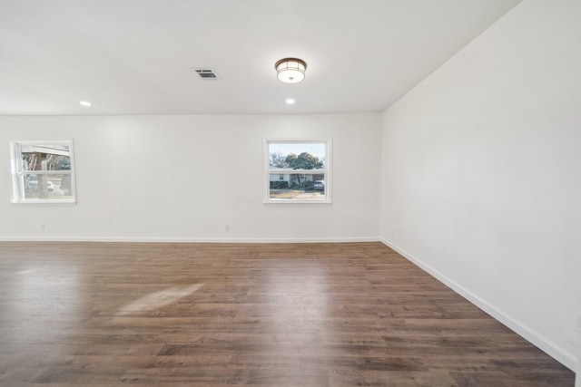 unfurnished room with dark wood-type flooring