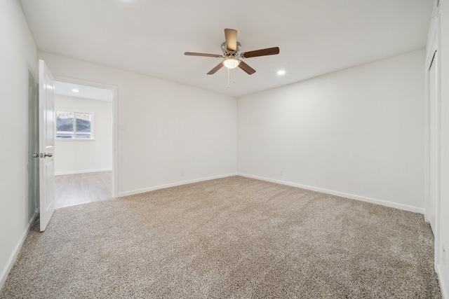 empty room featuring ceiling fan and carpet floors