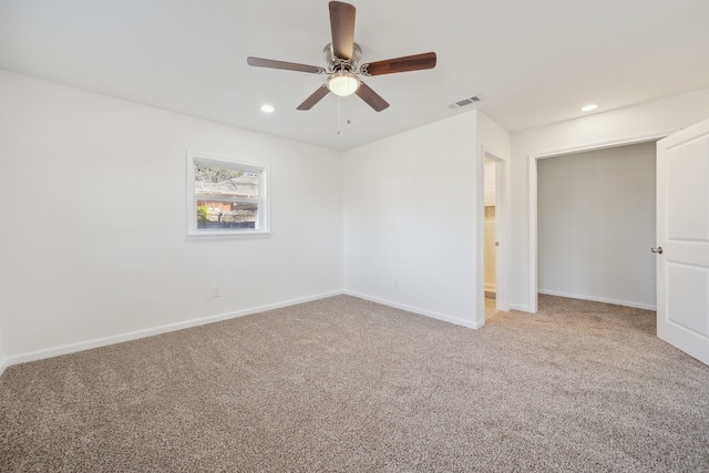 unfurnished room featuring ceiling fan and carpet