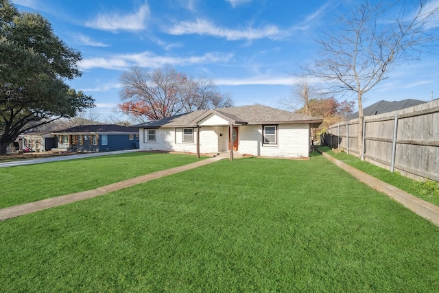 ranch-style house featuring a garage and a front lawn