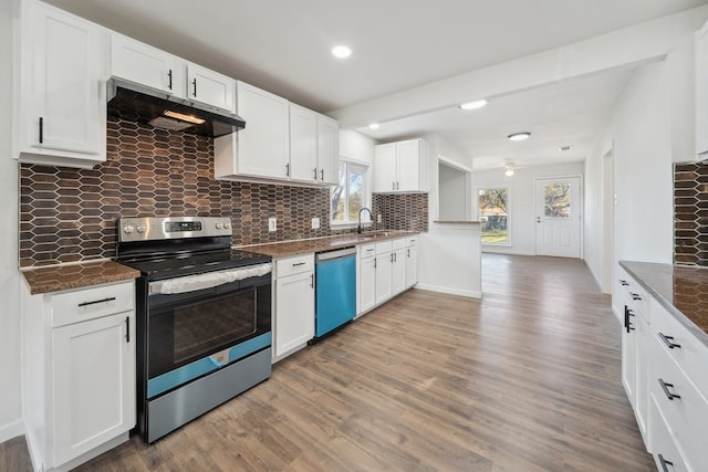 kitchen featuring decorative backsplash, appliances with stainless steel finishes, white cabinetry, and wood-type flooring