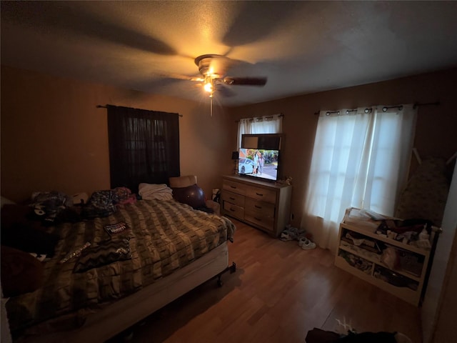 bedroom featuring ceiling fan and light hardwood / wood-style floors