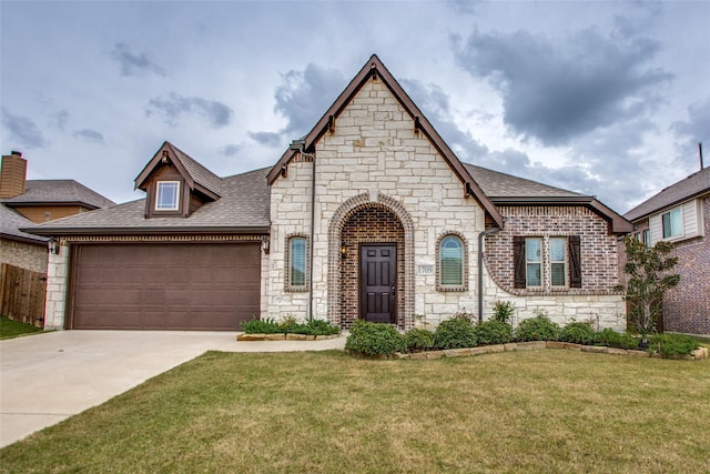 view of front of property featuring a garage and a front lawn