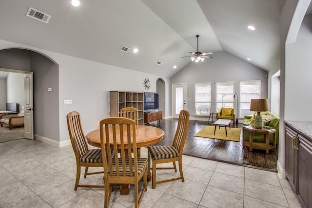 tiled dining area featuring high vaulted ceiling and ceiling fan