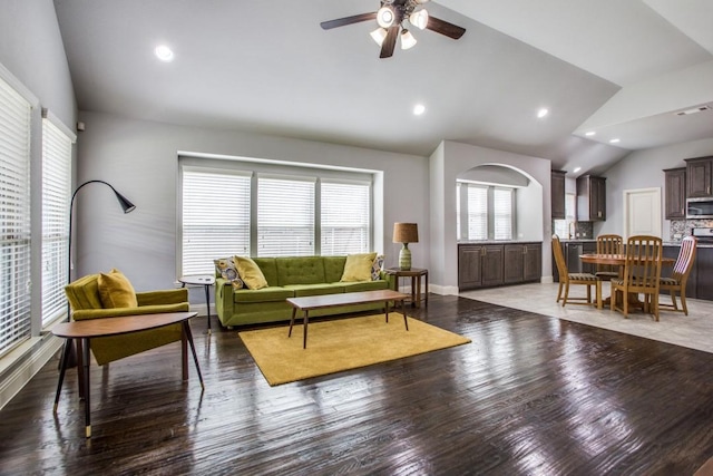 living room featuring hardwood / wood-style flooring, lofted ceiling, and ceiling fan