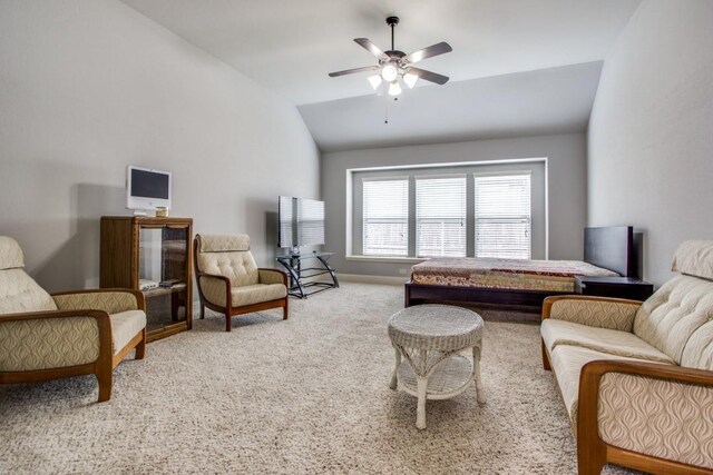 living room with lofted ceiling, ceiling fan, and carpet