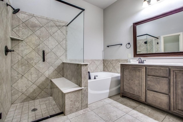 bathroom featuring tile patterned flooring, vanity, and plus walk in shower