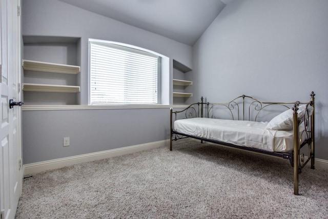 carpeted bedroom featuring lofted ceiling