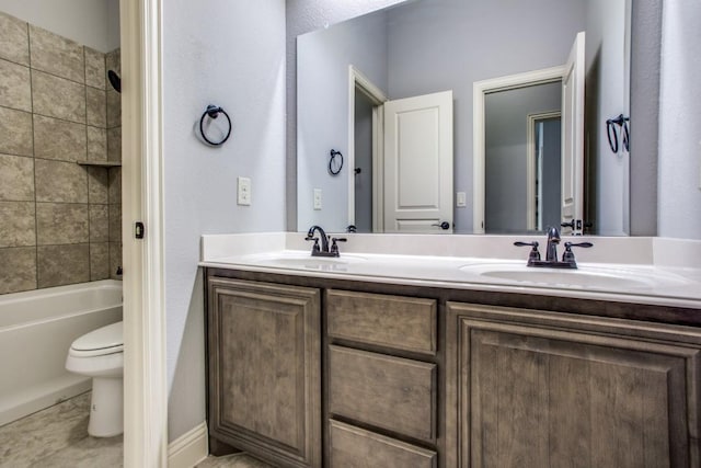 full bathroom with vanity, tiled shower / bath, and toilet