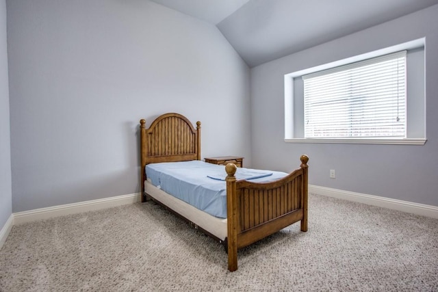 bedroom with vaulted ceiling and carpet