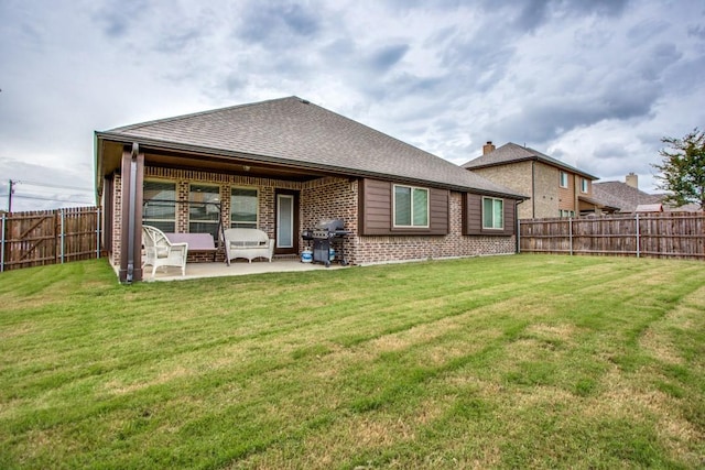 back of house with a yard and a patio area