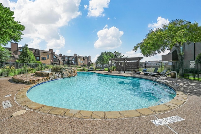 pool with a patio area, fence, a residential view, and a pergola