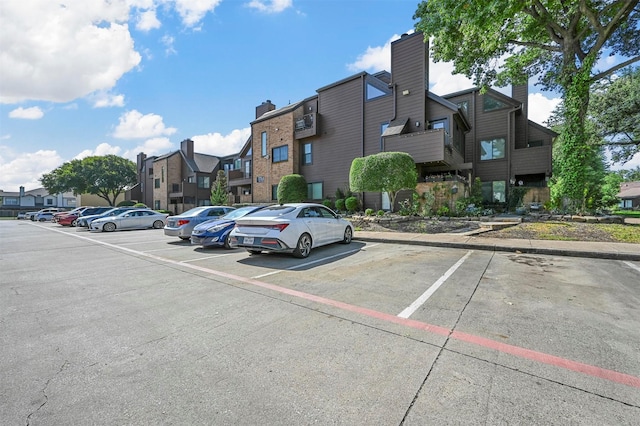 uncovered parking lot featuring a residential view