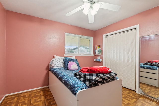 bedroom with ceiling fan and dark parquet floors