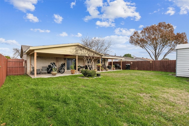 rear view of house with a patio area and a yard