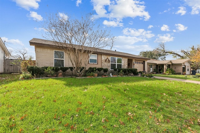 ranch-style home with a garage and a front yard