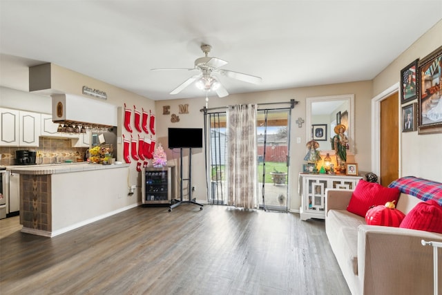 living room featuring ceiling fan and dark wood-type flooring