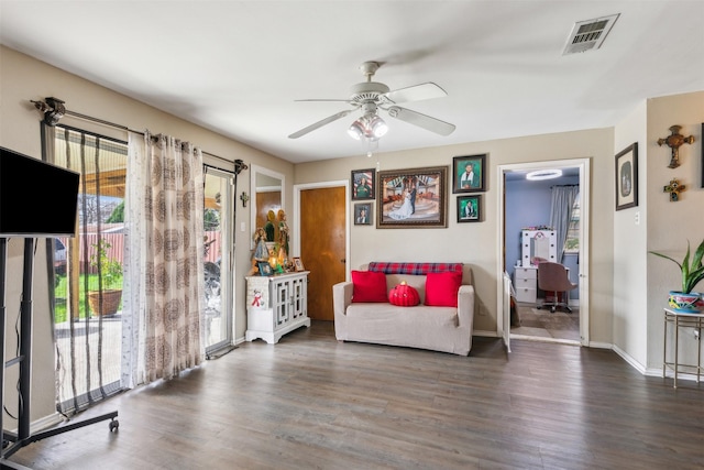 living room featuring dark hardwood / wood-style floors and ceiling fan