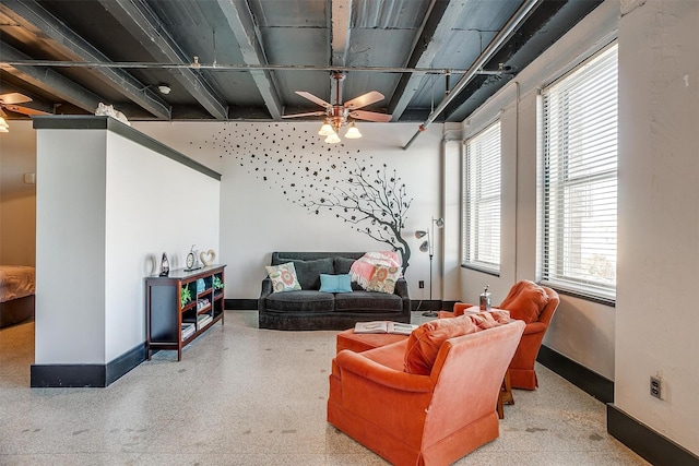 living room featuring plenty of natural light and ceiling fan