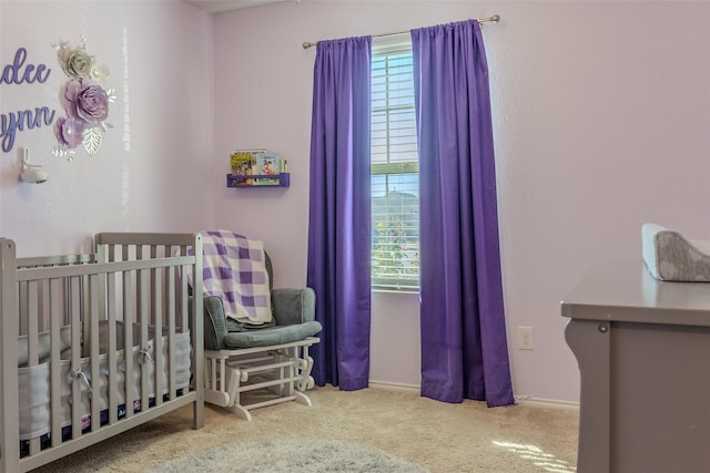 carpeted bedroom featuring a crib