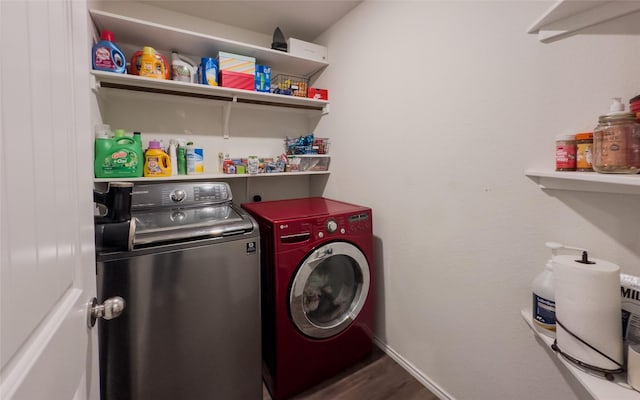 washroom featuring dark hardwood / wood-style flooring and washer and clothes dryer