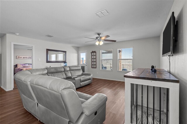 living room with ceiling fan and wood-type flooring