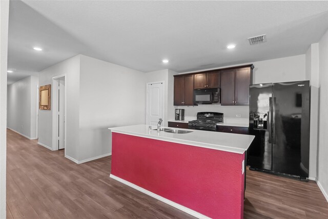 living room with ceiling fan, sink, and hardwood / wood-style floors