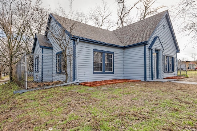 view of side of property with a lawn