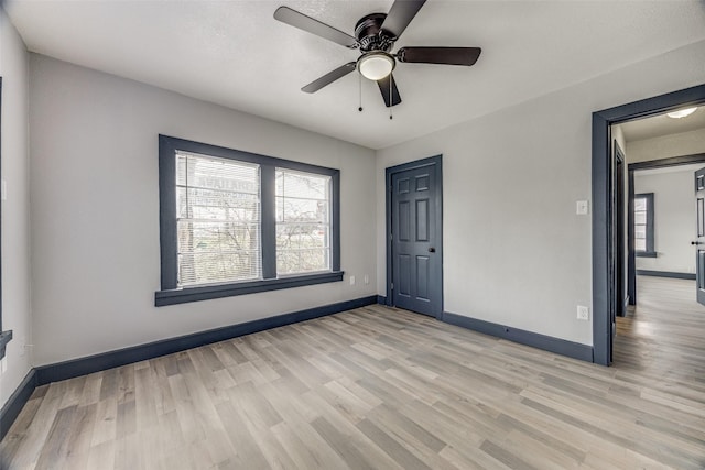 spare room with light hardwood / wood-style floors and ceiling fan