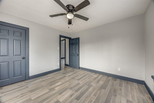 unfurnished bedroom with ceiling fan and light hardwood / wood-style flooring