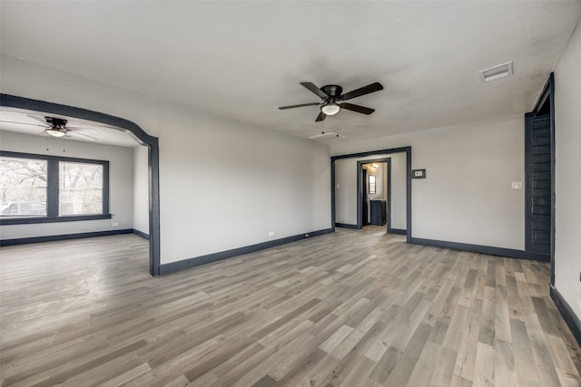 empty room with light hardwood / wood-style floors and ceiling fan