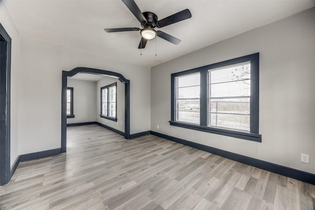 spare room with ceiling fan and light wood-type flooring