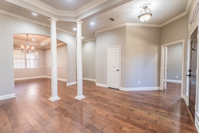 basement featuring a chandelier, dark hardwood / wood-style floors, and ornamental molding