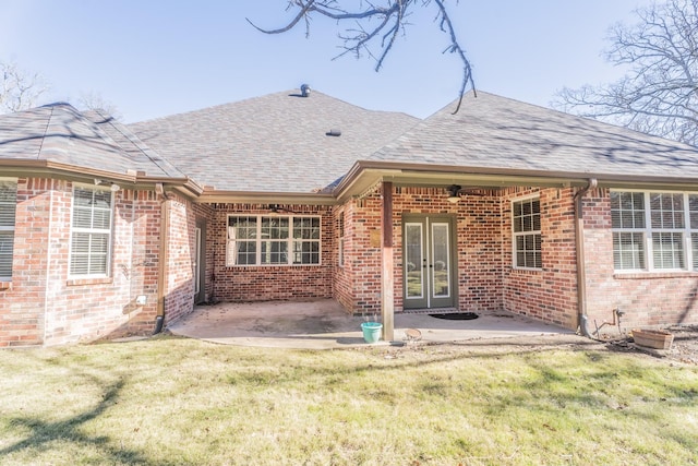 back of property featuring french doors, a yard, and a patio area